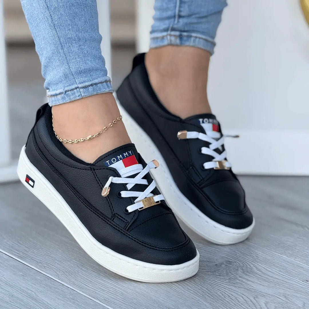Tenis Bolichero Lupita negros con suela blanca antideslizante, detalles metálicos dorados, interior acolchonado de espuma para máxima comodidad, diseño ergonómico y transpirable ideal para uso diario y estilo urbano.