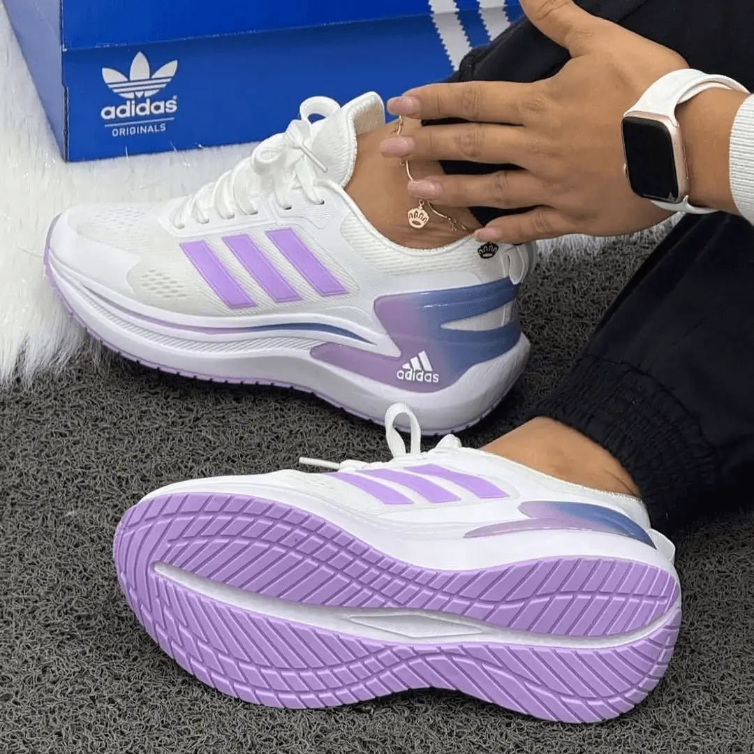 Zapatillas Bounce deportivas blancas con detalles lila, entresuela de espuma reactiva para amortiguación superior, suela antiderrapante y diseño ergonómico para confort y estilo al correr o caminar
