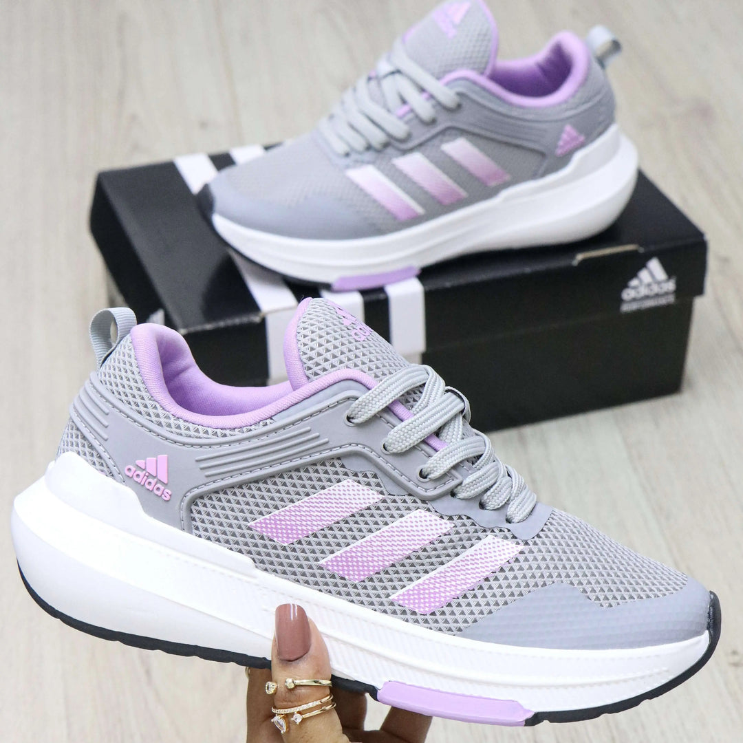 Zapatillas deportivas para mujer en tonos gris y lila, con suela blanca antideslizante, diseño transpirable de malla para mayor comodidad y ajuste perfecto, ideales para caminatas y uso diario que proporcionan soporte y estilo moderno.