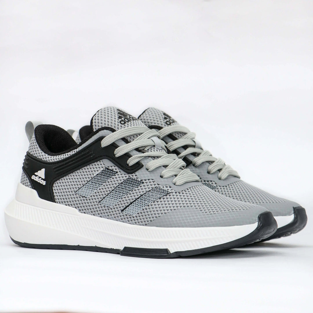 Zapatillas deportivas Falcon en color gris con suela blanca antideslizante, diseño transpirable y cómodo para uso diario y entrenamiento, ideales para brindar soporte y ligereza en cada paso.