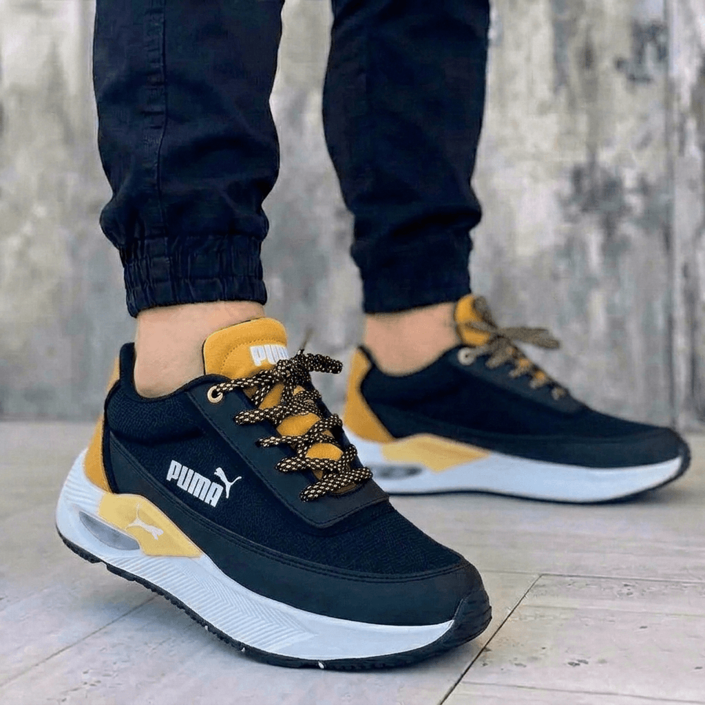 Zapatillas Puma para hombre negras y amarillas con plataforma y amortiguación. Calzado deportivo casual con suela blanca gruesa.