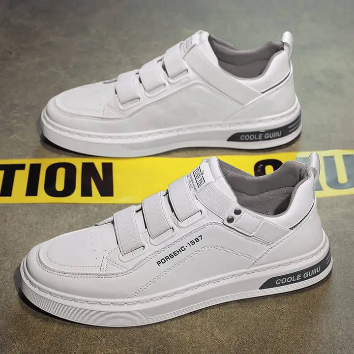 Zapatos deportivos blancos para hombre, diseño moderno con cierre de velcro, suela antideslizante y cómoda, ideales para uso diario y actividades casuales, fabricados con materiales duraderos y transpirables para máximo confort y estilo urbano contemporáneo.