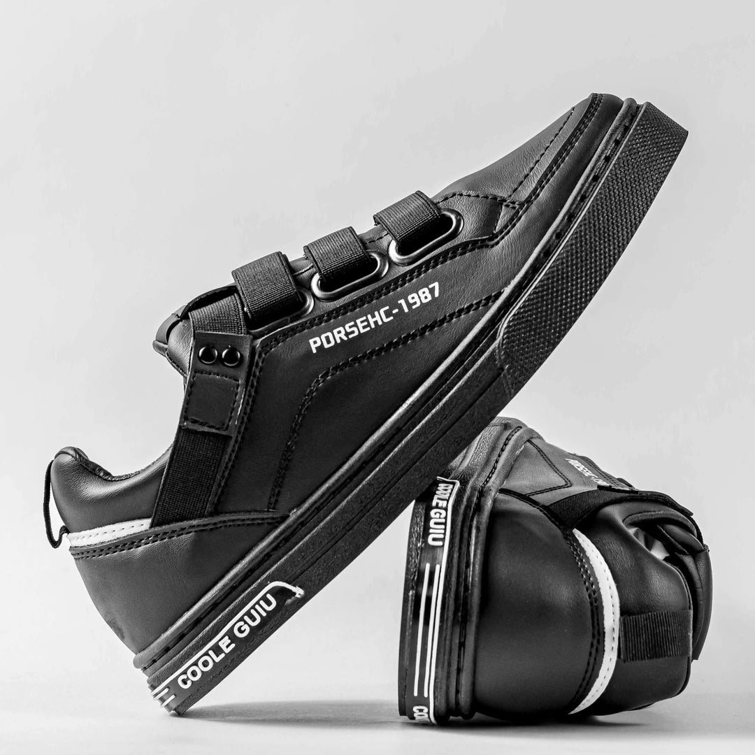 Zapatos deportivos negros con cierre de velcro, diseño moderno y cómodo, suela antideslizante para mayor seguridad y resistencia, ideales para uso diario y estilo casual en hombres y mujeres.