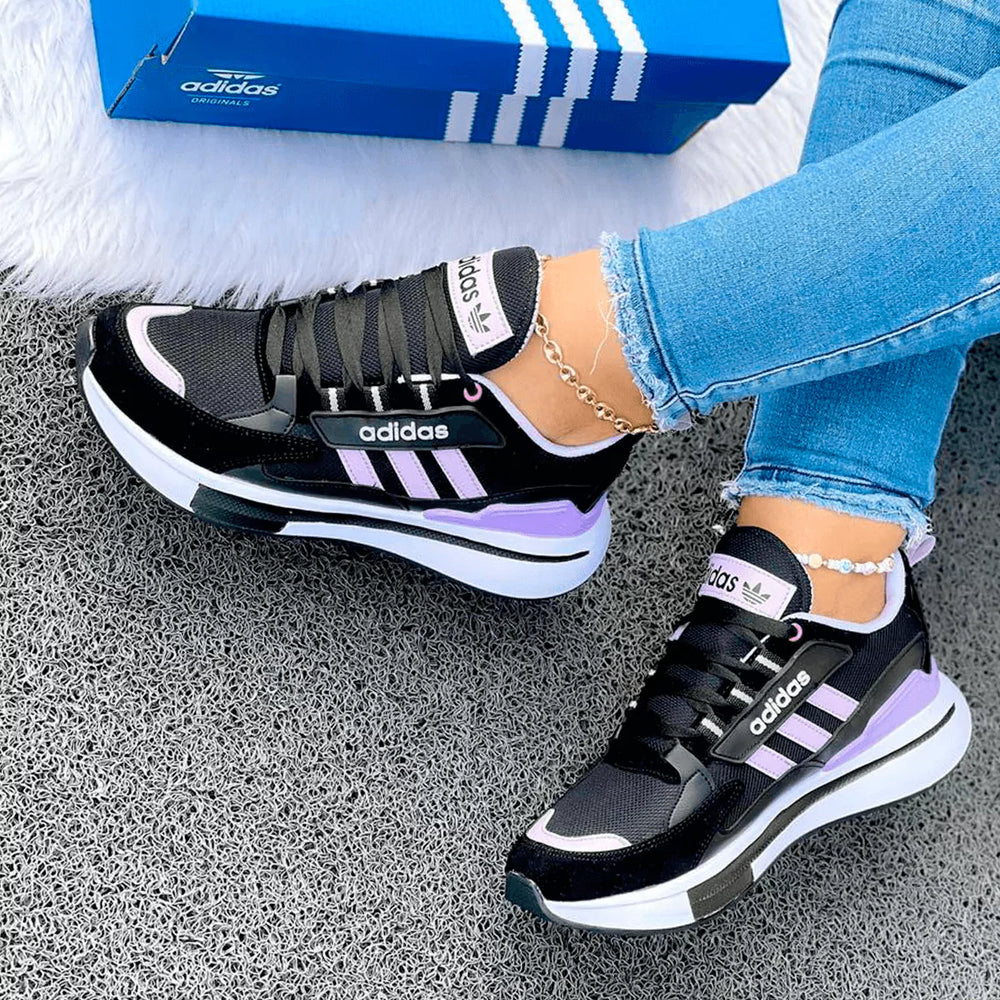 Tenis Fit Pro en negro y lila con suela blanca, estilo moderno para destacar cualquier outfit casual.