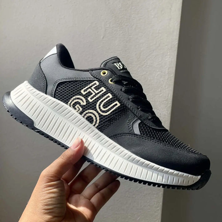 Zapatillas deportivas negras para hombre con suela blanca antideslizante, diseño moderno y transpirable con materiales resistentes, ideales para uso diario cómodo y casual en Colombia.