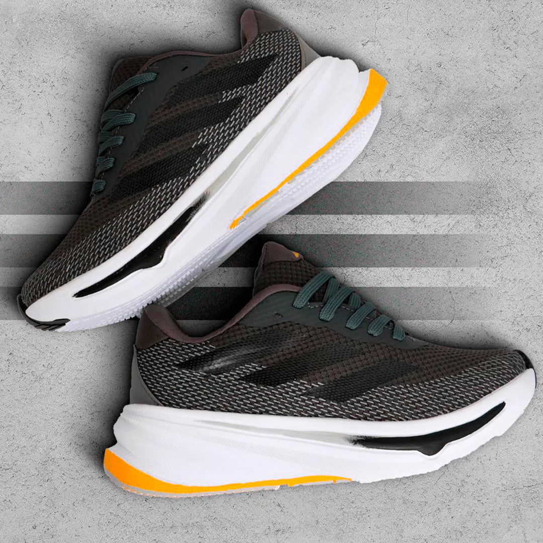Zapatillas deportivas gris con detalles en naranja, diseño ligero y transpirable, suela acolchada para máxima amortiguación y soporte, ideales para correr y entrenamiento diario, calzado cómodo y resistente para rendimiento óptimo.